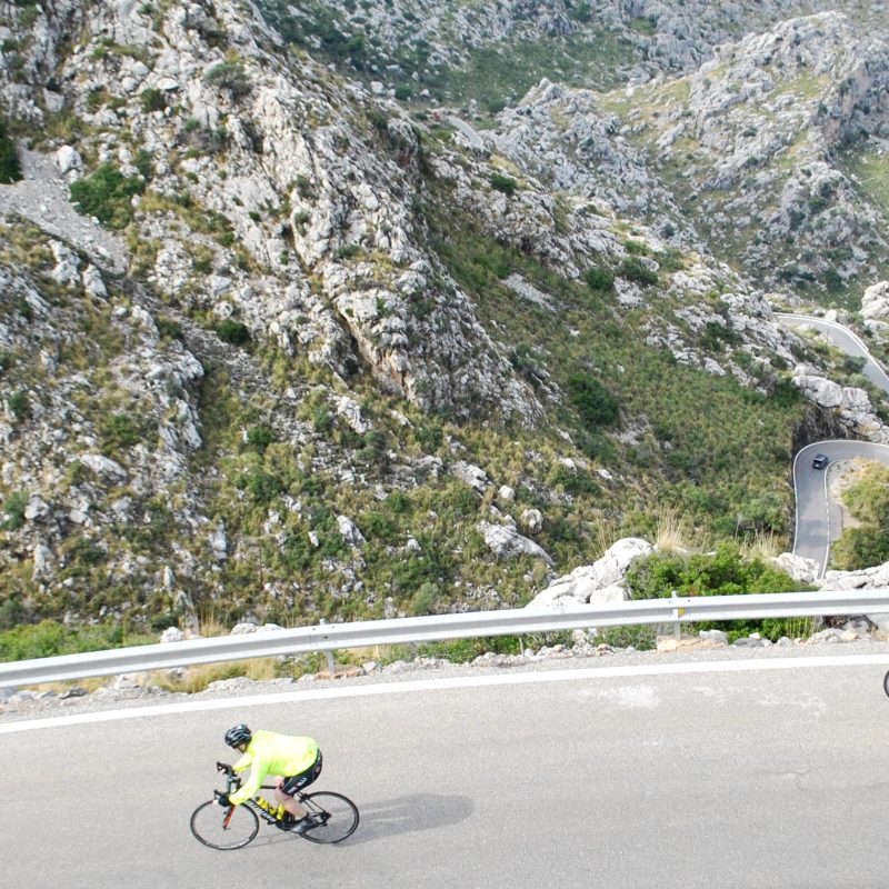 Cyclist cycling the fantastic sa calobra in Majorca in the sunshine on this organised cycling holiday in Majorca with European Cycling Tours