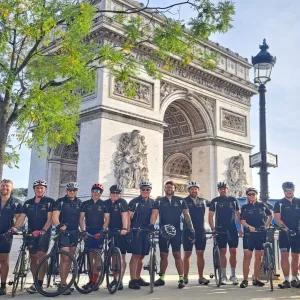 Cyclists at Arc de Triomphe after cycling London to Paris in 3 days with European cycling tours fully supported and guided London to Paris bike ride