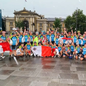 Large group of cyclists celebrating after cycling over 1000km to Belgrade from Prague after completing a charity fundraising cycling event managed by cycle events organiser European Cycling Tours