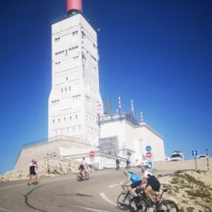 Cyclists riding bicycles from beautiful lake Annecy ona 4 day cycle tour through the French Alps to Alpe d'Huez and Mont Ventoux riding. Bike vacation organised by European Cycling Tours