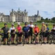 Cyclists admiring the renaissance architecture of château de chambord during an organized france bike tour
