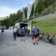Cyclists gathering around a professional european cycling tours support van for refreshments and mechanical assistance