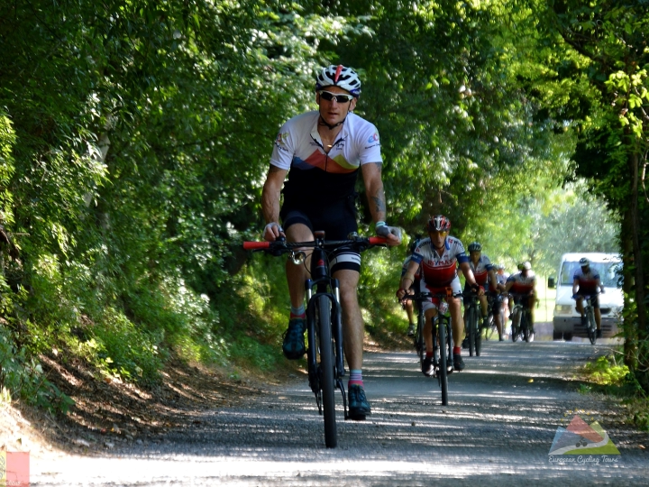 European Cycling Tours founder Jason Wright expertly guiding a group of cyclists on a long-distance European tour, demonstrating the safety and support of a professional guided holiday.