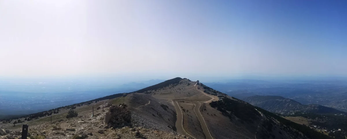 Panoramic cyclists view from the mont ventoux summit overlooking the provence hills during a guided cycling holiday browse our legendary mountain climb itineraries