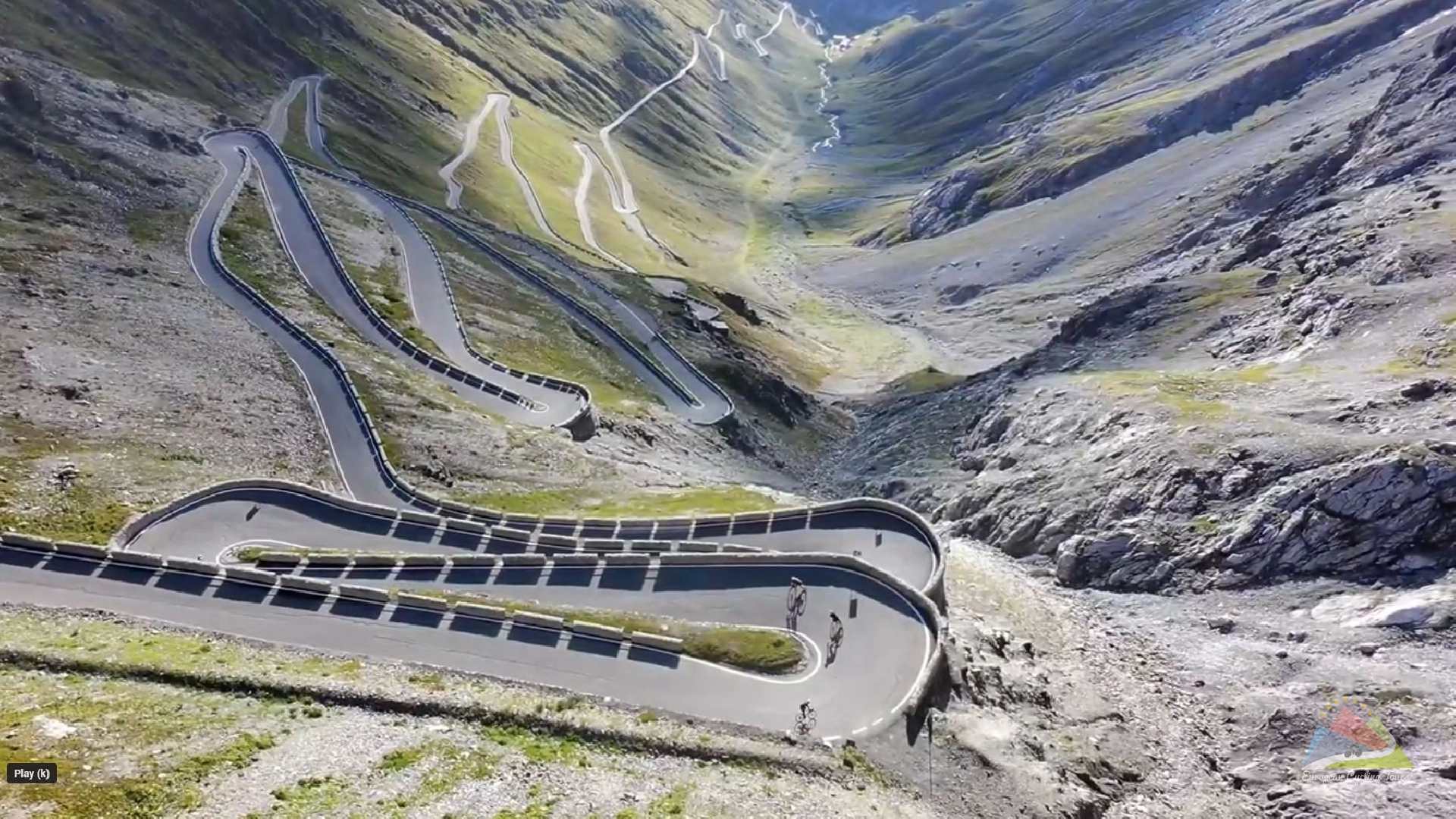 A group of road cyclists enjoying the technical descent of the stelvio pass zig zags in the italian alps explore our portfolio of guided tours covering the most legendary climbs in europe